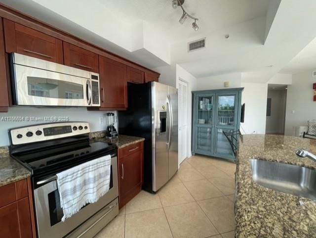7270 Southwest 88th Street, Unit B203 Miami, FL 33156 - Photo 3 of 13 a kitchen with a stove microwave and refrigerator