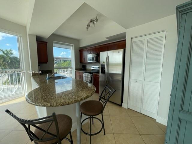 7270 Southwest 88th Street, Unit B203 Miami, FL 33156 - Photo 5 of 13 a dining room with furniture and a floor to ceiling window