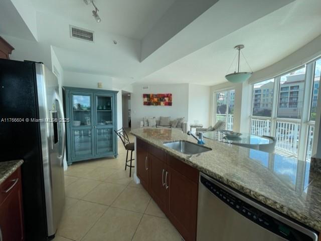 7270 Southwest 88th Street, Unit B203 Miami, FL 33156 - Photo 6 of 13 a kitchen with granite countertop a sink and a refrigerator