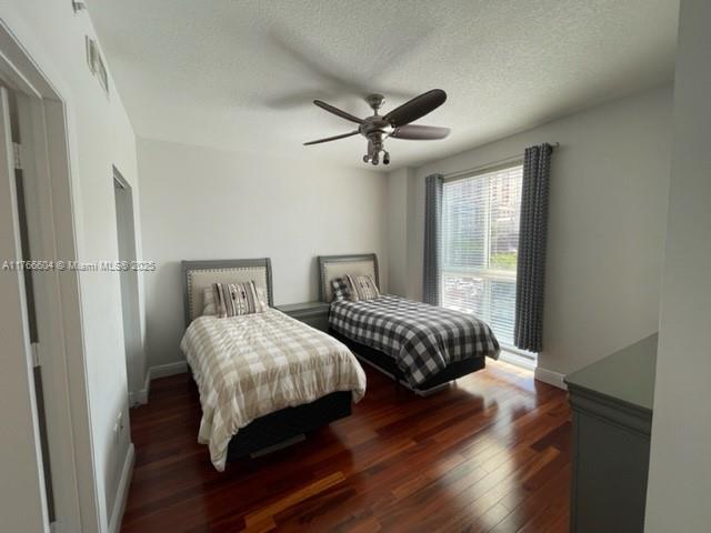 7270 Southwest 88th Street, Unit B203 Miami, FL 33156 - Photo 8 of 13 a bedroom with two beds and wooden floor