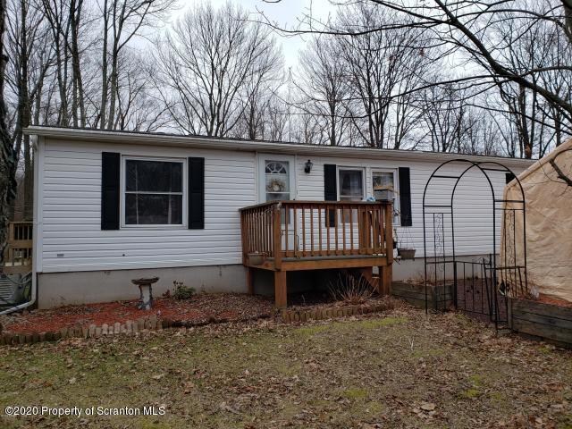 283 Bortree Road Moscow, PA 18444 - Photo 1 of 19 a backyard of a house with a garden and deck