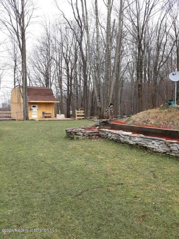283 Bortree Road Moscow, PA 18444 - Photo 13 of 19 a small pool with lawn chairs and trees
