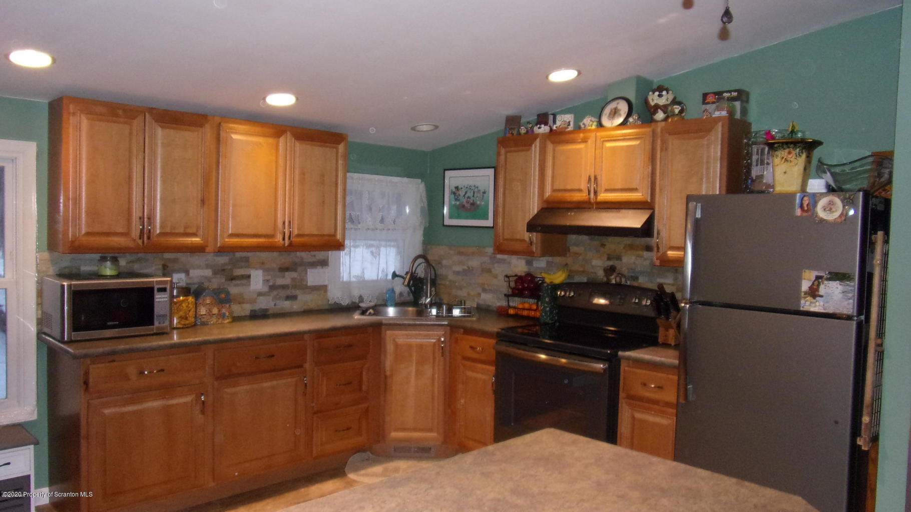 283 Bortree Road Moscow, PA 18444 - Photo 3 of 19 a kitchen with a sink a refrigerator and cabinets