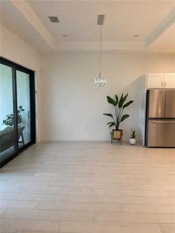 14866 Loggerhead Drive Naples, FL 34120 - Photo 7 of 16 a view of an empty room with a kitchen