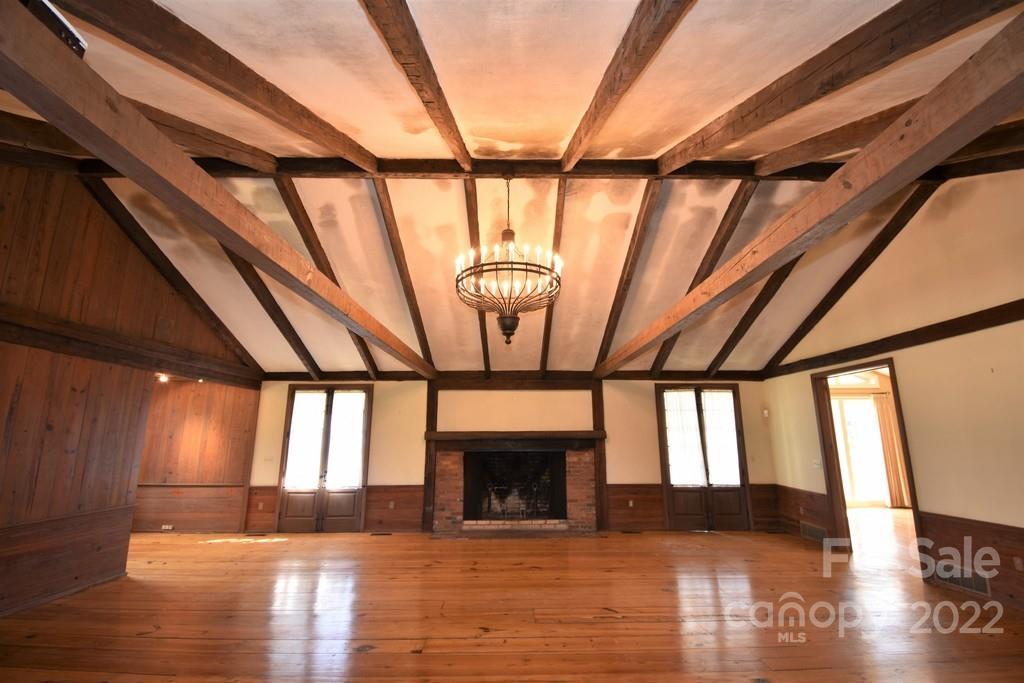 131 Block House Road Tryon, NC 28782 - Photo 8 of 47 a view of empty room with wooden floor and fireplace