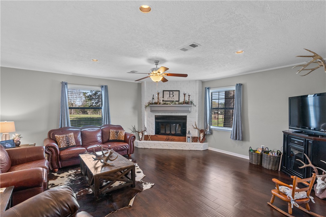9269 Wheelock Hall Road Hearne, TX 77859 - Photo 5 of 25 a living room with furniture a fireplace and a flat screen tv