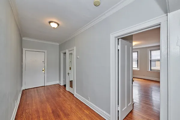 a view of a hallway with wooden floor