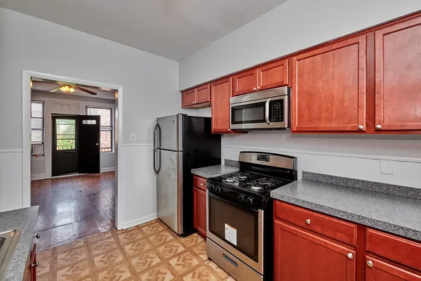 a kitchen with stainless steel appliances granite countertop a refrigerator stove and microwave