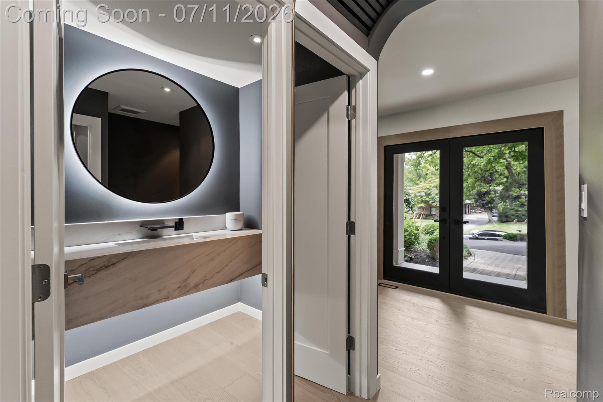 4154 Nearbrook Road Bloomfield Hills, MI 48302 - Photo 8 of 47 Powder room featuring a floating vanity with a stone countertop and a round backlit mirror