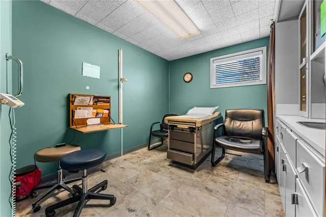 a room with furniture gym equipment and a window