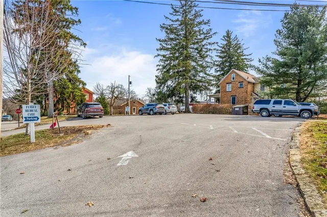 a view of road with card and trees