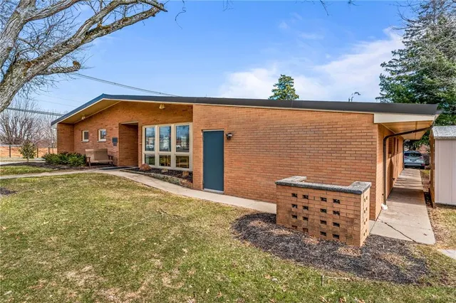 a front view of a house with large windows