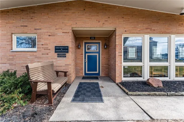 a view of a brick house with many windows