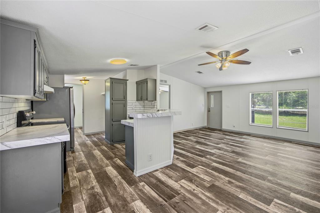 4950 80 Street Chiefland, FL 32626 - Photo 17 of 68 a view of a kitchen with a sink dishwasher a refrigerator and a stove top oven