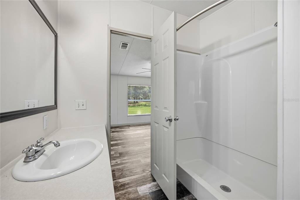 4950 80 Street Chiefland, FL 32626 - Photo 24 of 68 a bathroom with a sink and a mirror