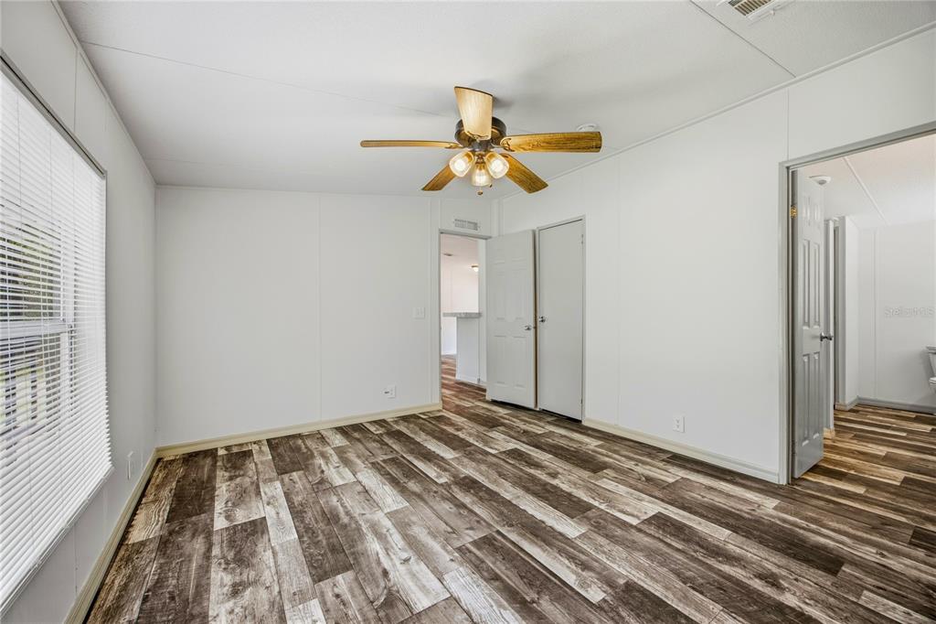 4950 80 Street Chiefland, FL 32626 - Photo 29 of 68 a bedroom with a bed and a chandelier fan