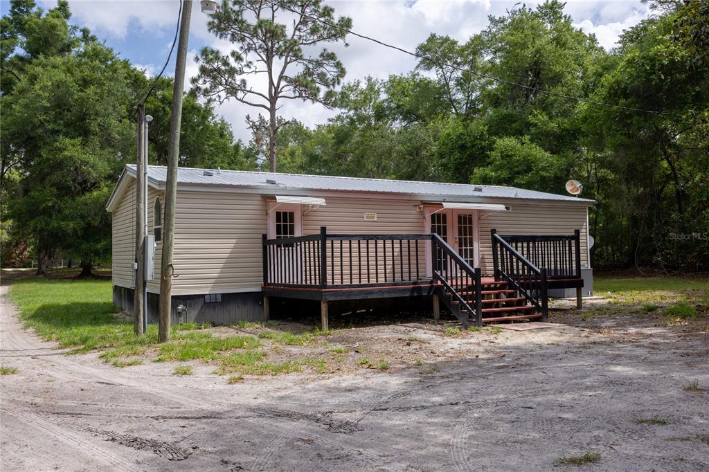 4950 80 Street Chiefland, FL 32626 - Photo 34 of 68 a view of a house with a yard and sitting area