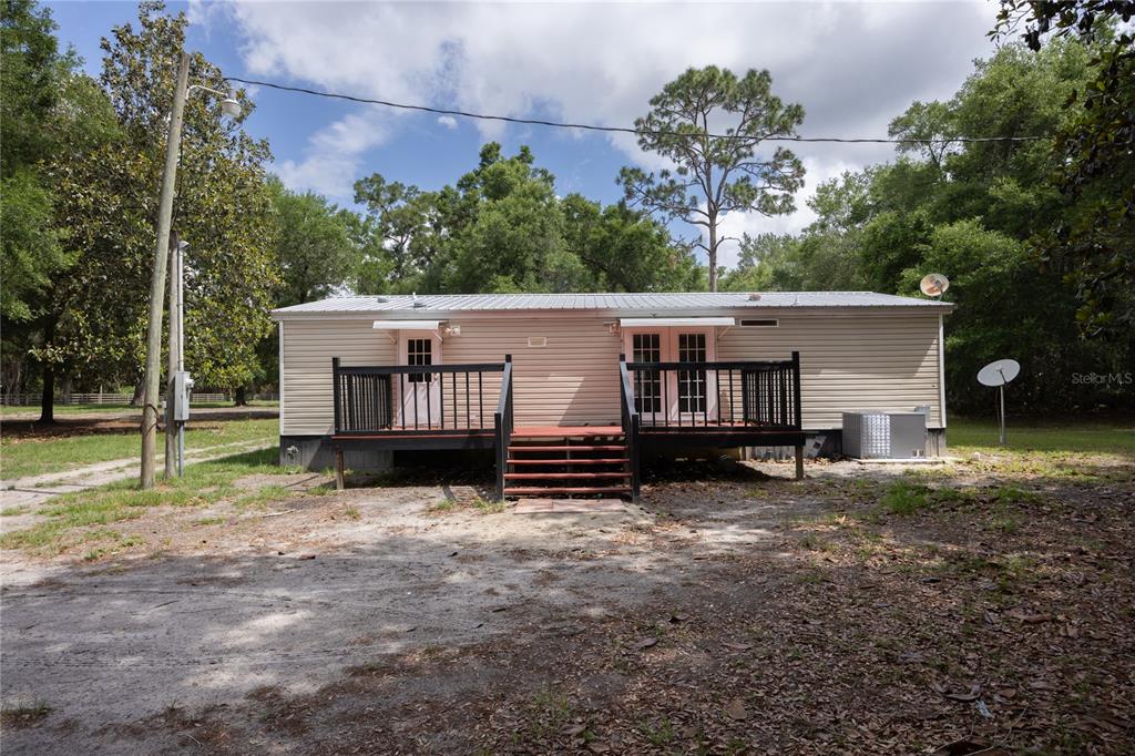 4950 80 Street Chiefland, FL 32626 - Photo 35 of 68 a view of a house with backyard and a tree