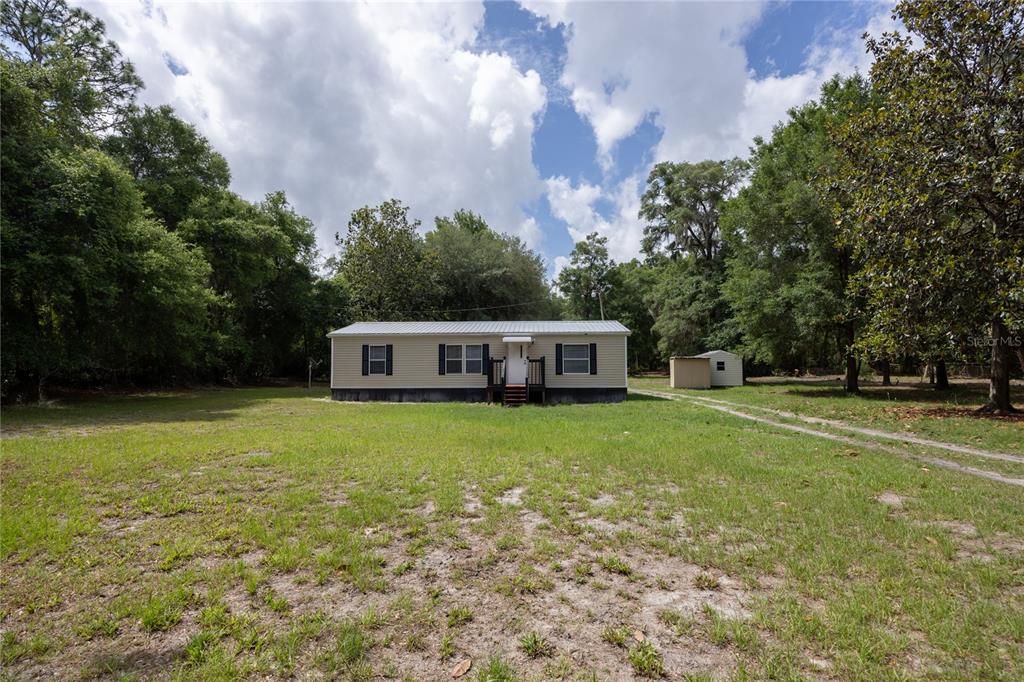 4950 80 Street Chiefland, FL 32626 - Photo 4 of 68 a front view of a house with garden