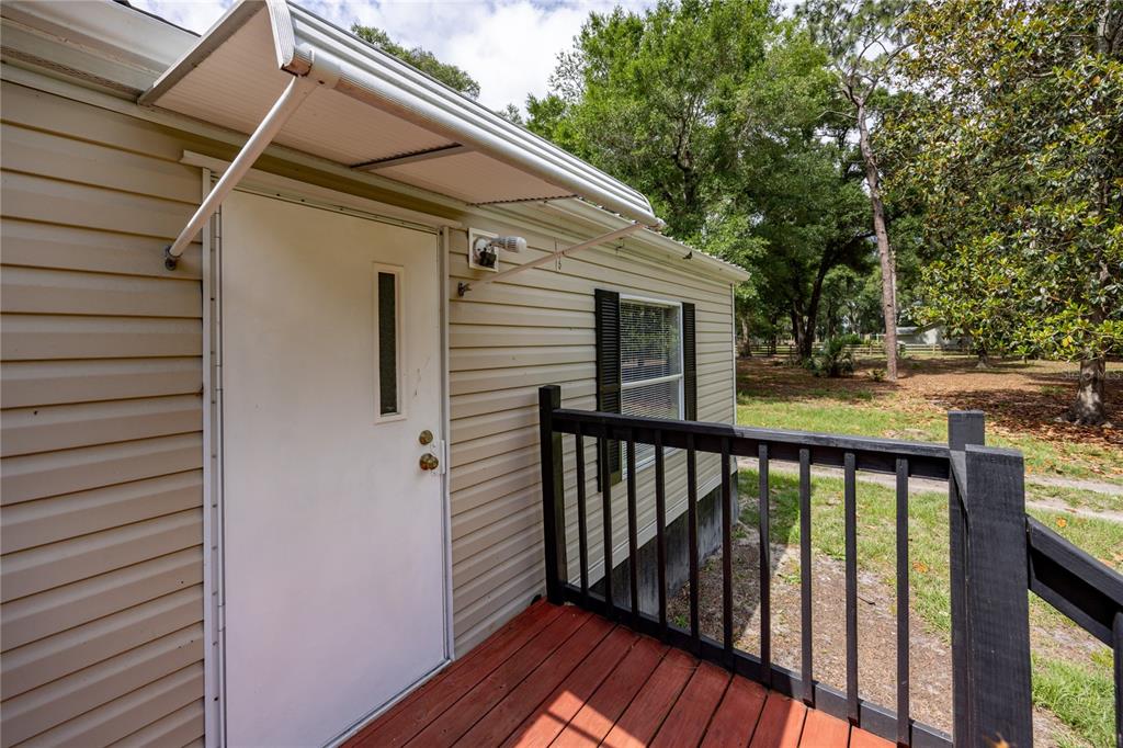 4950 80 Street Chiefland, FL 32626 - Photo 8 of 68 a view of a balcony with wooden floor and fence