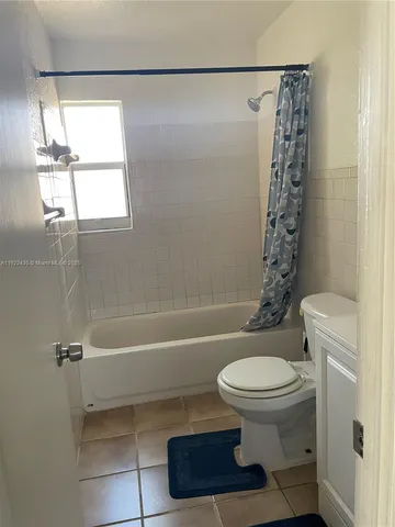 a view of a backyard with large trees