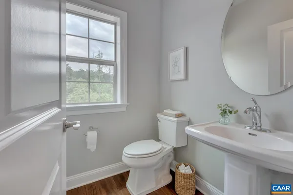 a bathroom with a sink toilet and a mirror