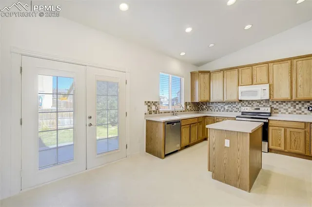 a kitchen with stainless steel appliances a refrigerator and a stove top oven