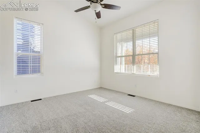 a view of a livingroom with a ceiling fan and window