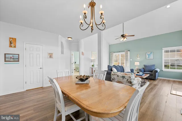 a bedroom with a bed and a chandelier fan