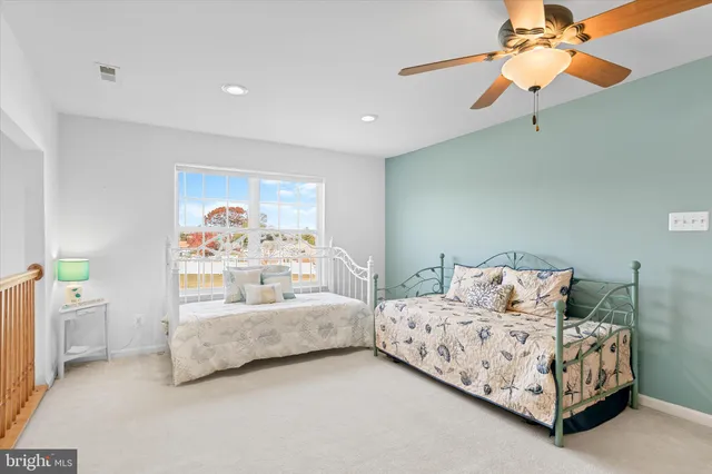 a spacious bathroom with a granite countertop sink and a mirror