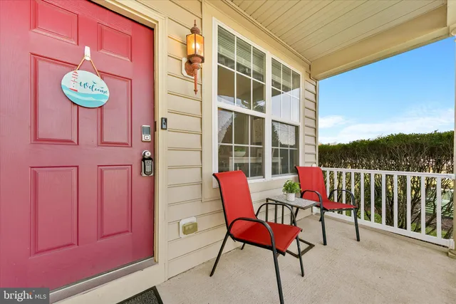 a balcony with table and chairs