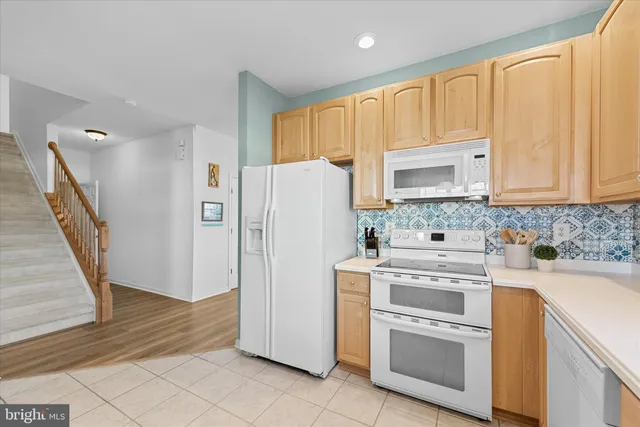 a kitchen with stainless steel appliances a sink stove and refrigerator
