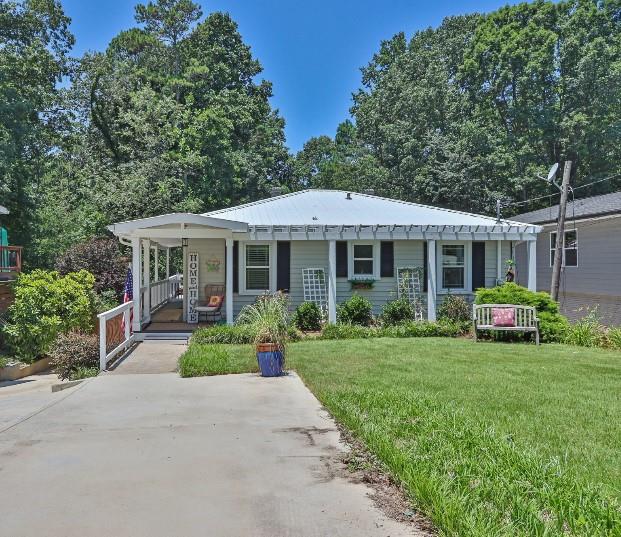 a front view of a house with yard and green space