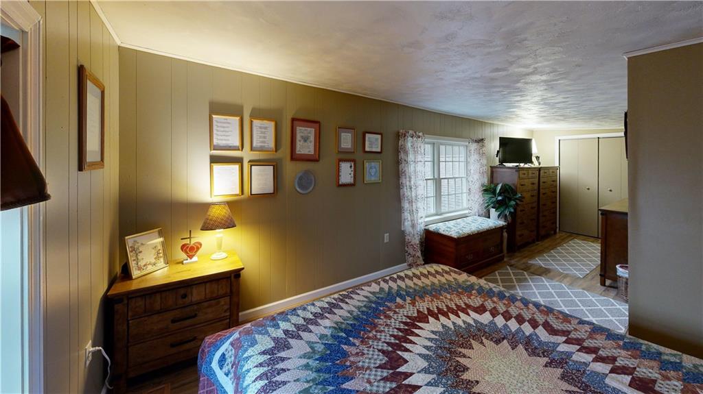 174 Rose Lane Rimersburg, PA 16248 - Photo 27 of 34 a bedroom with a bed and wooden floor