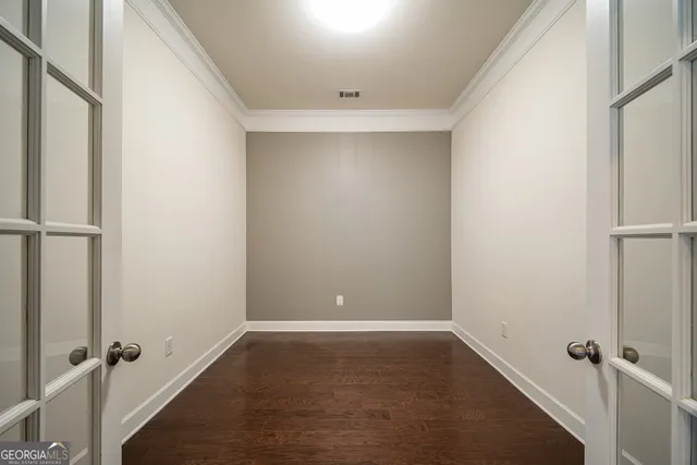 a view of a room with wooden floor and a ceiling fan
