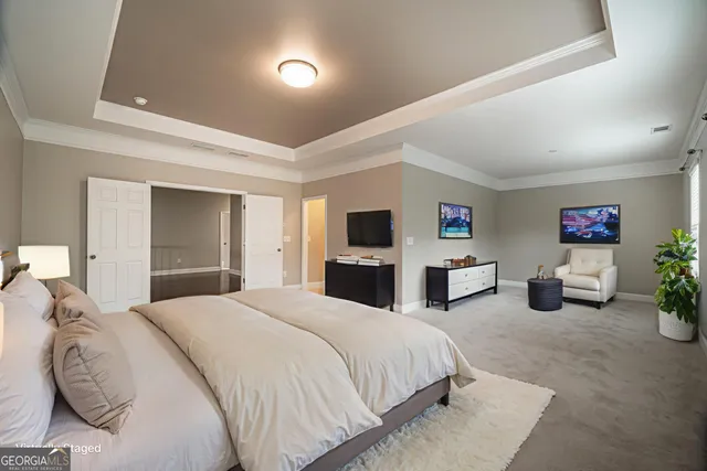 a spacious bedroom with a bed and furniture