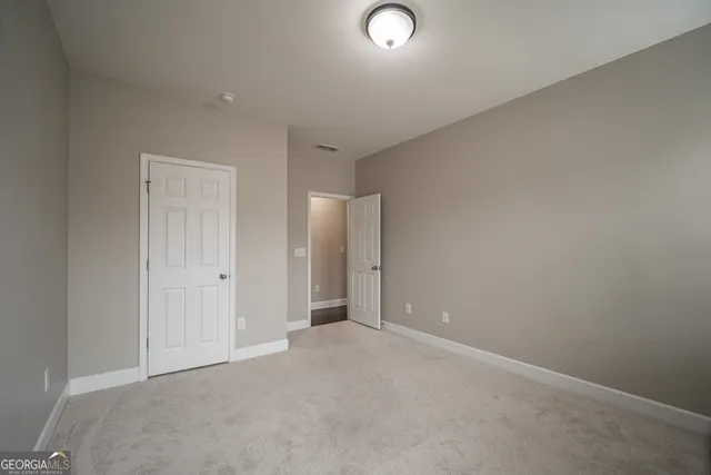 an empty room with closet area