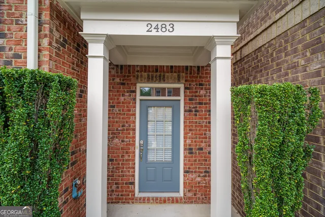 a front view of a building with a garden