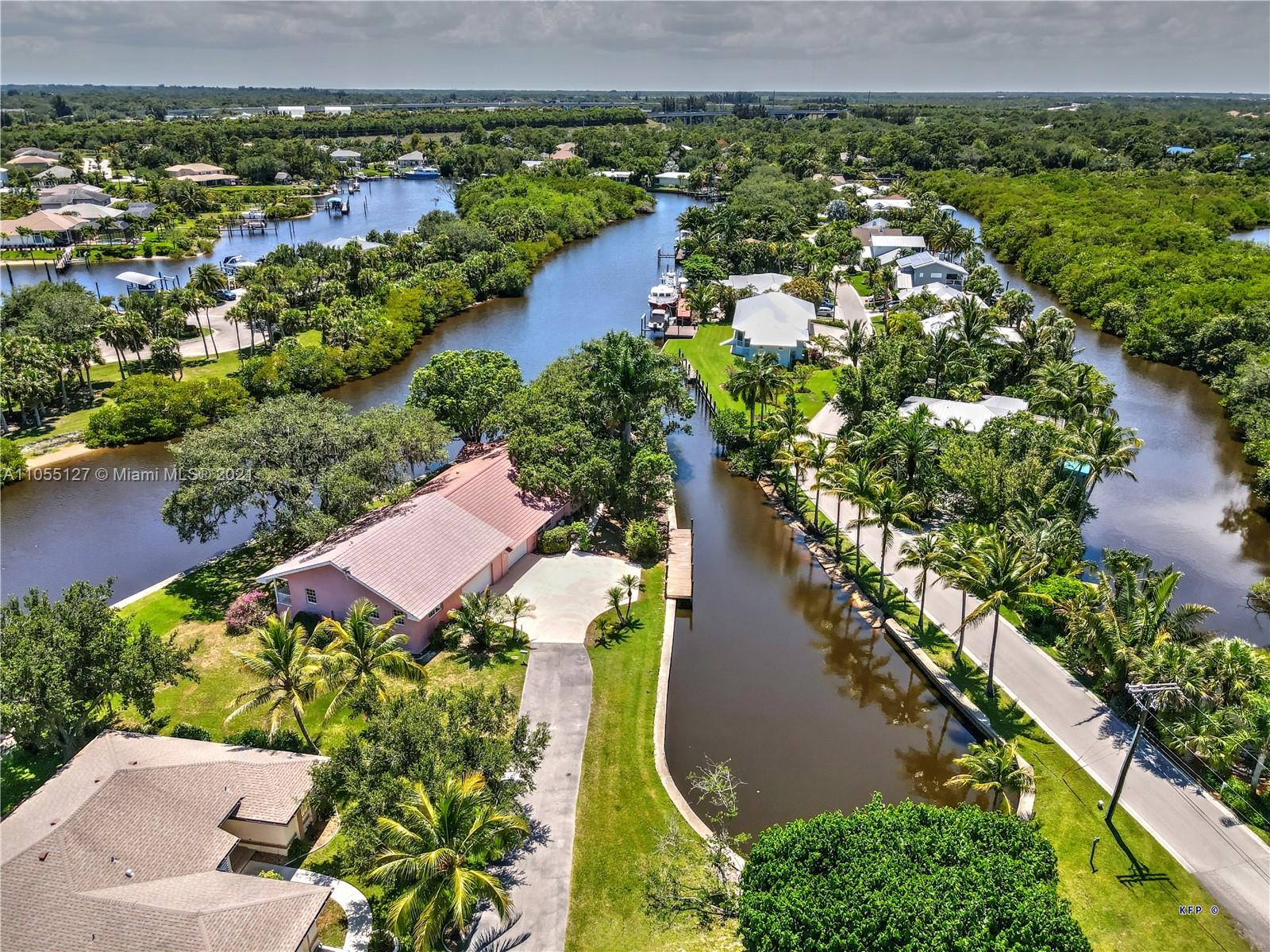 540 Southwest Salerno Road Stuart, FL 34997 - Photo 1 of 44 an aerial view of a house with a yard and lake view