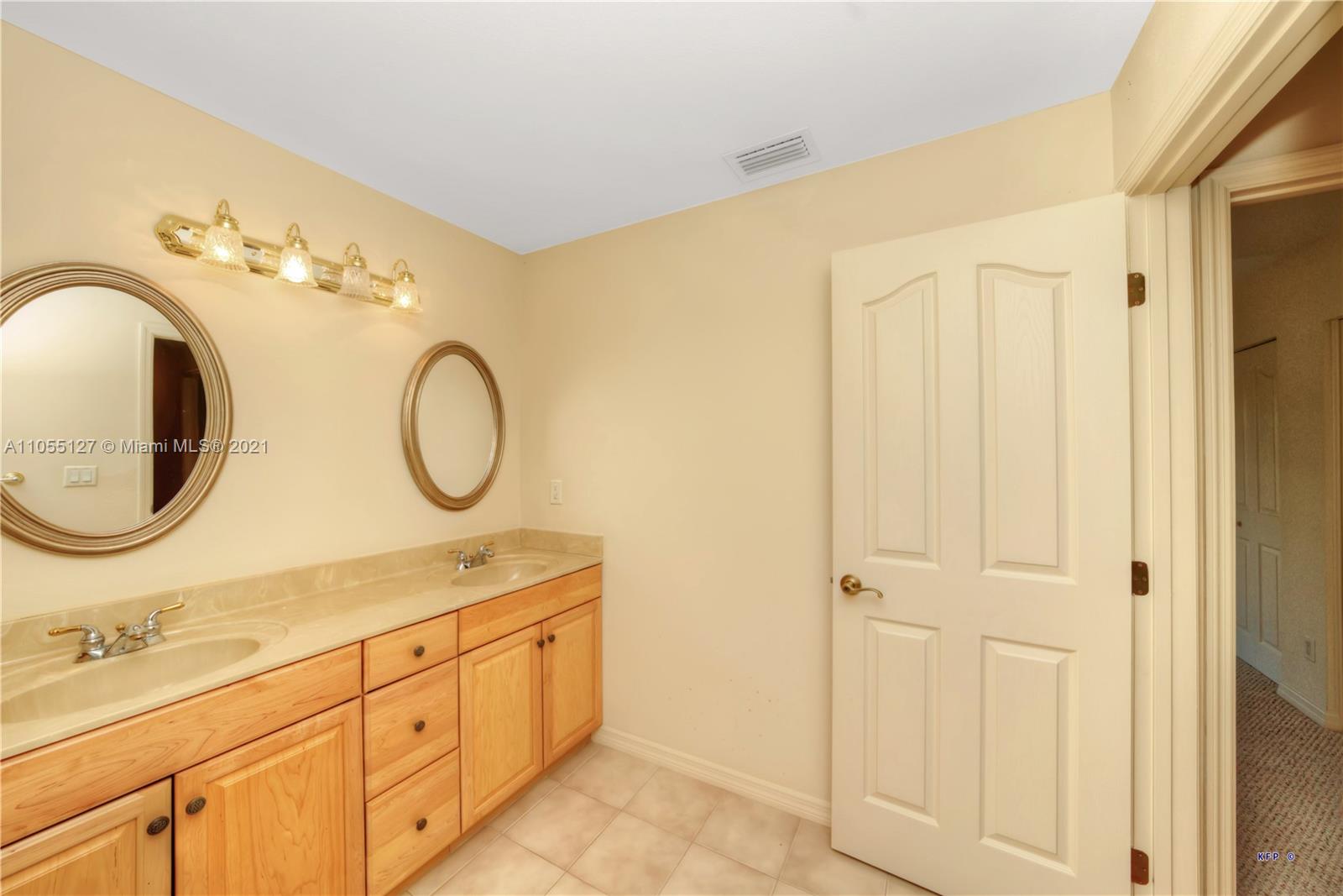 540 Southwest Salerno Road Stuart, FL 34997 - Photo 24 of 44 a spacious bathroom with a granite countertop sink and a mirror