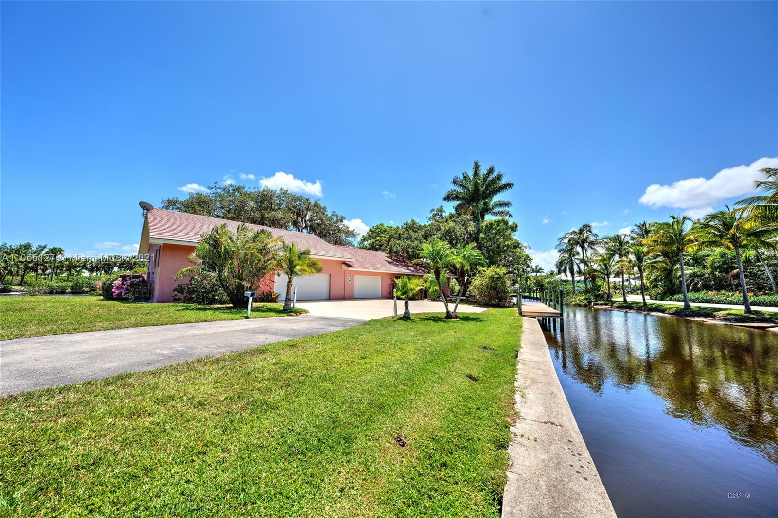 540 Southwest Salerno Road Stuart, FL 34997 - Photo 30 of 44 a view of a house with a yard and a pond