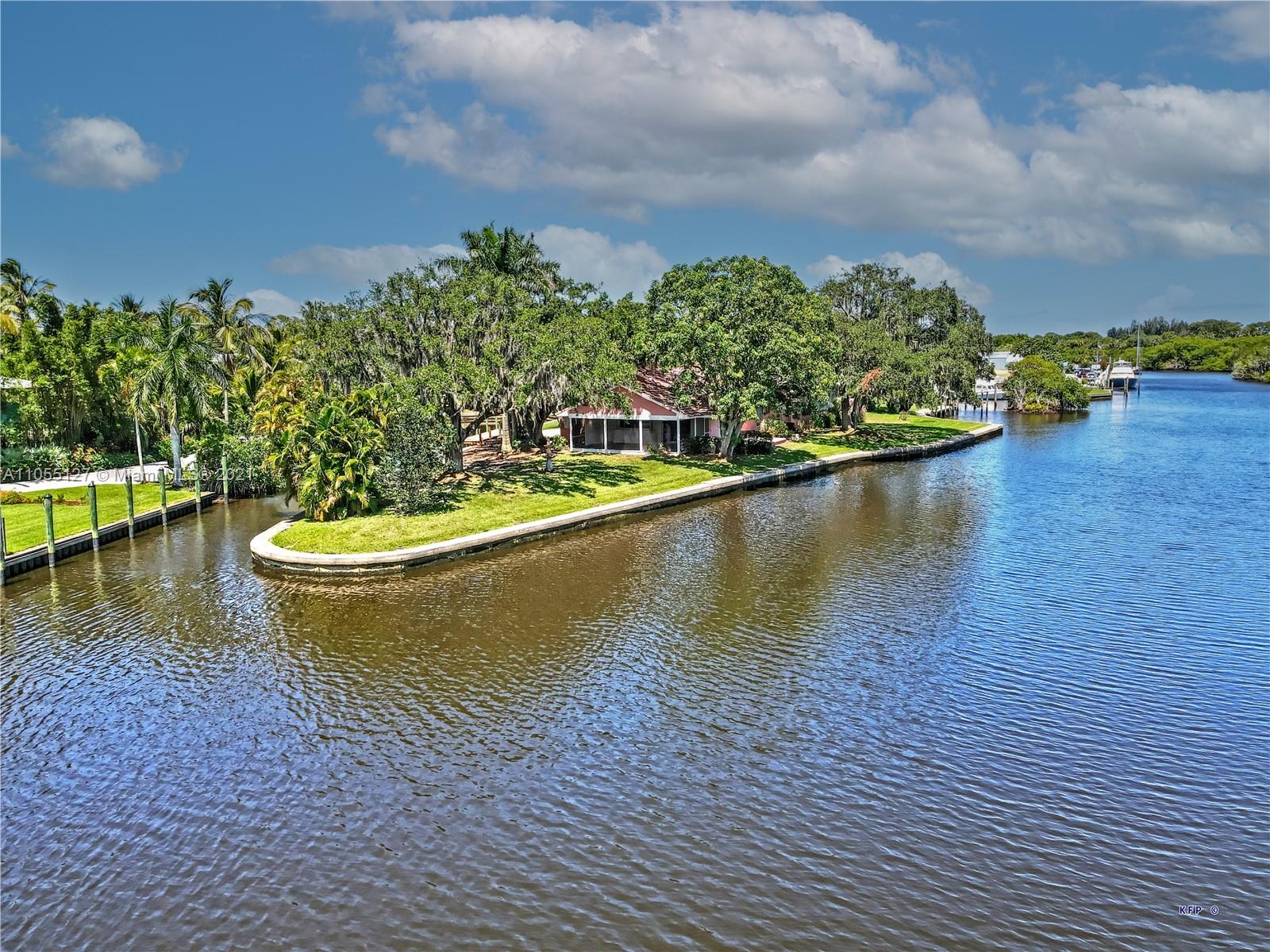 540 Southwest Salerno Road Stuart, FL 34997 - Photo 4 of 44 a view of a lake with a house