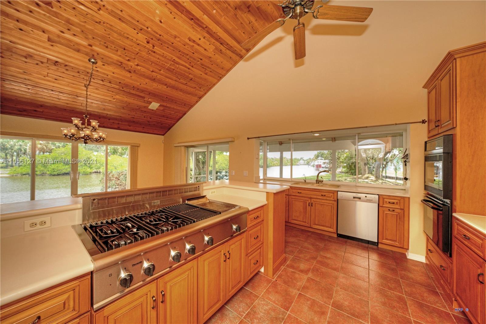 540 Southwest Salerno Road Stuart, FL 34997 - Photo 7 of 44 a kitchen with stainless steel appliances a stove a sink and a refrigerator