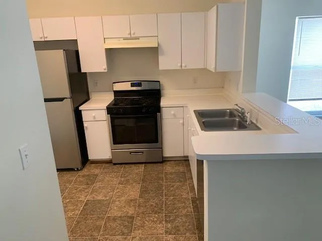 a view of empty room with ceiling fan