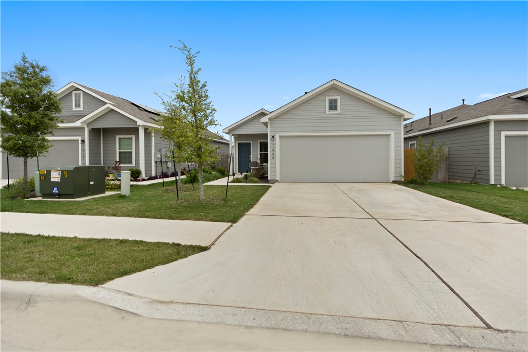 a front view of house with garage and yard