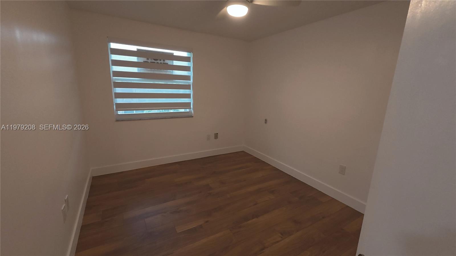 7121 Southwest 129th Avenue, Unit 8 Miami, FL 33183 - Photo 8 of 13 a view of empty room with wooden floor
