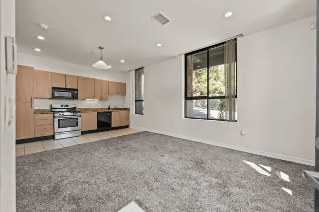 a large kitchen with stainless steel appliances granite countertop a stove and a sink with granite countertops