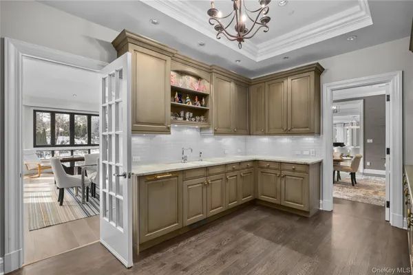 a kitchen with stainless steel appliances granite countertop a sink cabinets and wooden floor