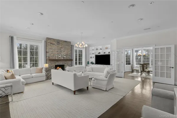 a living room with furniture large window and a fireplace