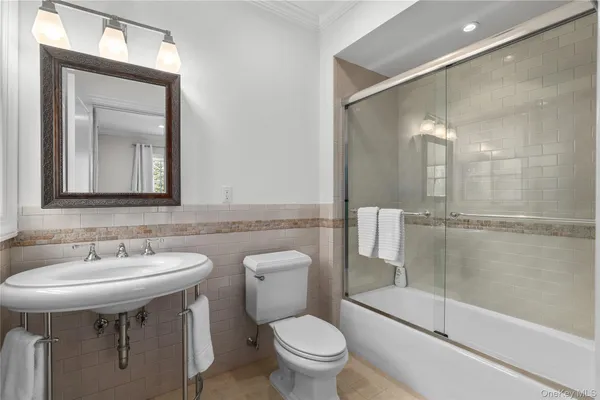 a living room with furniture and a book shelf